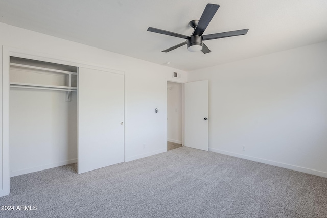 unfurnished bedroom featuring carpet flooring, ceiling fan, and a closet