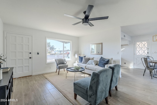 living room featuring ceiling fan and light hardwood / wood-style flooring