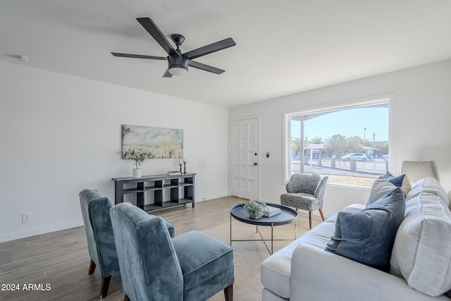 living room with ceiling fan and hardwood / wood-style flooring