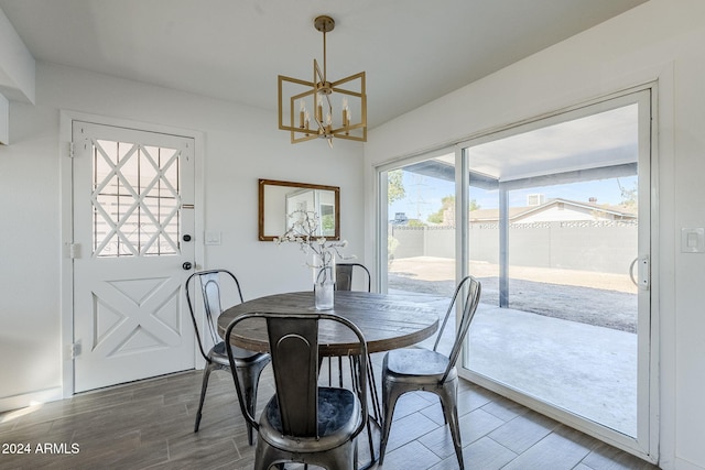 dining area featuring wood-type flooring and a notable chandelier