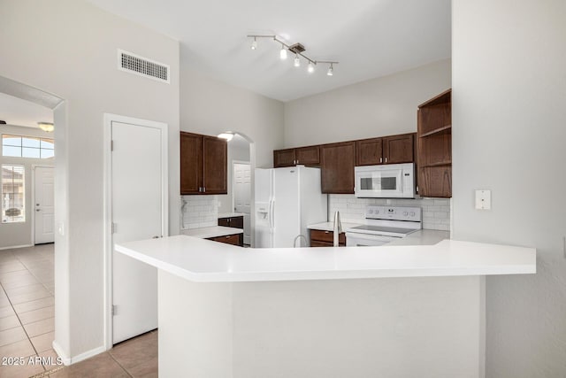 3713 W Nancy Ln, Phoenix, AZ 85041 - kitchen featuring white appliances, light tile patterned floors, open shelves, and tasteful backsplash