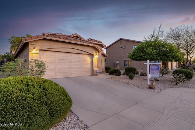 3713 W Nancy Ln, Phoenix, AZ 85041 - mediterranean / spanish home with driveway, a garage, stucco siding, and a tiled roof