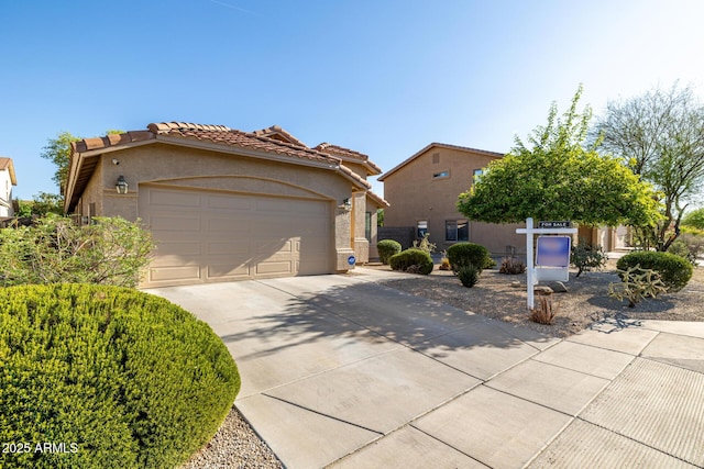 3713 W Nancy Ln, Phoenix, AZ 85041 - view of front of home featuring stucco siding, concrete driveway, a garage, and a tile roof