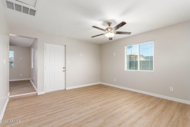 spare room featuring ceiling fan and light wood-type flooring