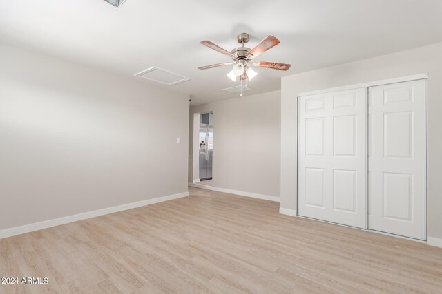 unfurnished bedroom featuring a closet, ceiling fan, and light wood-type flooring