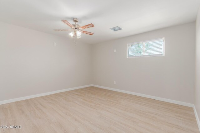 empty room with light wood-type flooring and ceiling fan