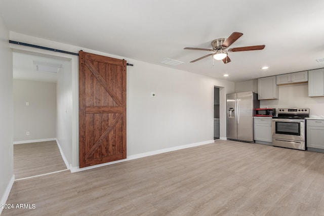 9424 N 2nd Pl, Phoenix, AZ 85020 - kitchen featuring a barn door, gray cabinets, stainless steel appliances, light countertops, and light wood-style floors