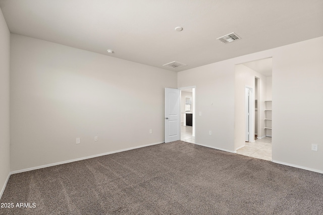 unfurnished room featuring light colored carpet, baseboards, and visible vents