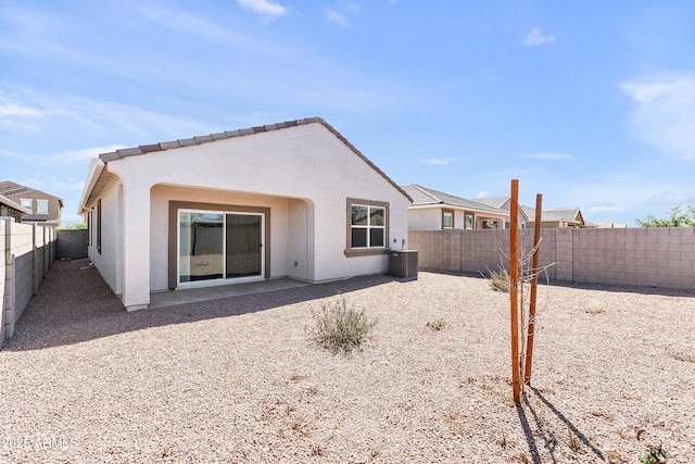 back of property featuring central air condition unit, a fenced backyard, a patio area, and stucco siding