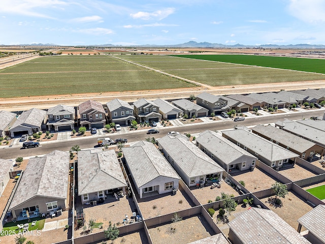 bird's eye view featuring a rural view, a residential view, and a mountain view