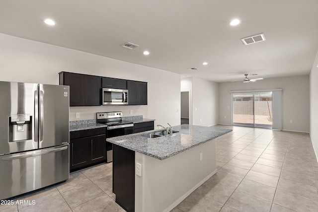 kitchen with ceiling fan, a sink, stainless steel appliances, light tile patterned floors, and visible vents