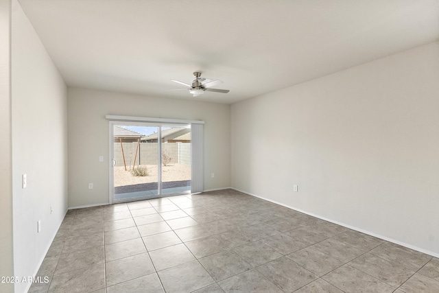 empty room featuring light tile patterned flooring, ceiling fan, and baseboards