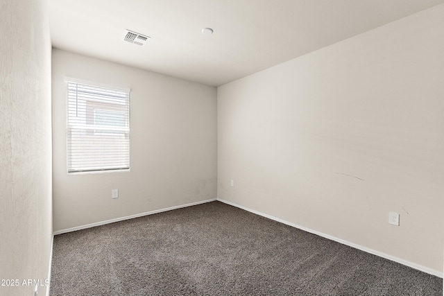 empty room featuring baseboards, carpet, and visible vents