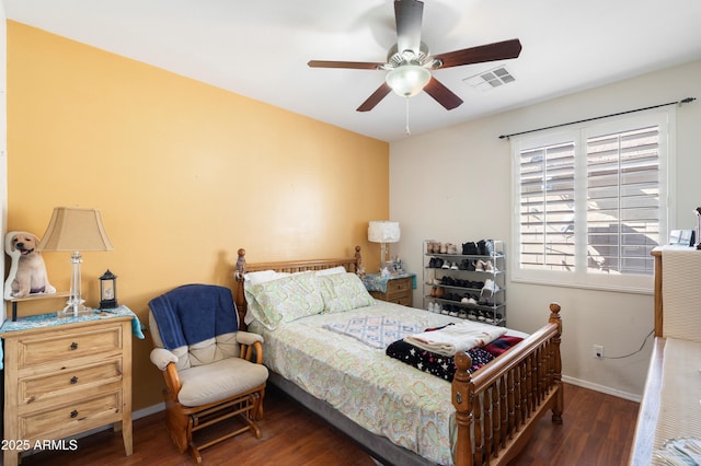 bedroom featuring a ceiling fan, dark wood-style flooring, visible vents, and baseboards