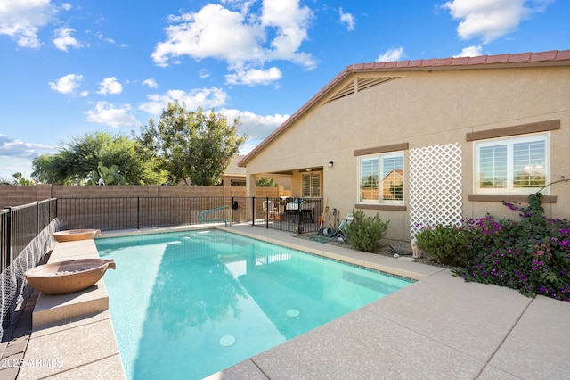 view of pool with a fenced in pool, a patio area, and a fenced backyard