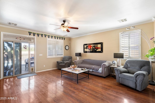 living room with ornamental molding, dark wood-style flooring, and visible vents