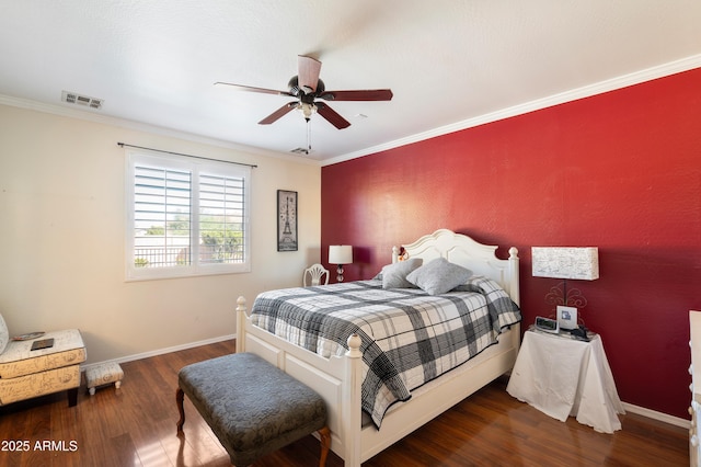 bedroom featuring baseboards, visible vents, a ceiling fan, dark wood-style floors, and crown molding