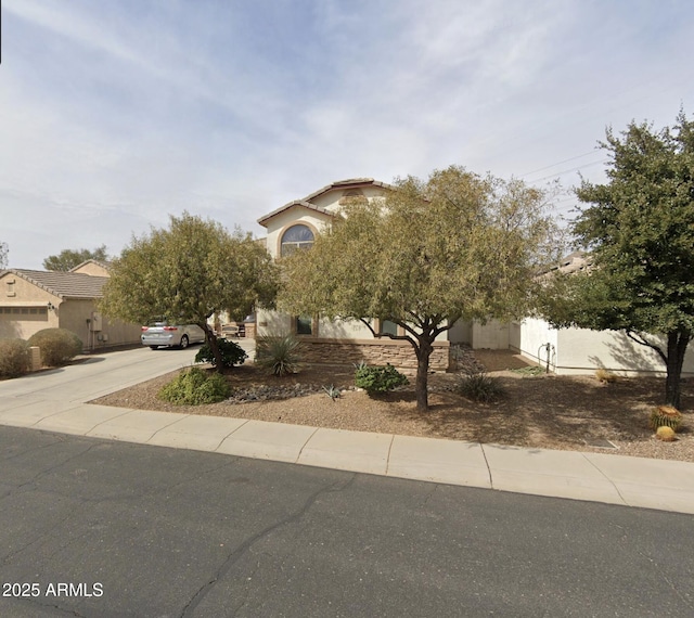 2556 E Quiet Hollow Ln, Phoenix, AZ 85024 - obstructed view of property with driveway and stucco siding