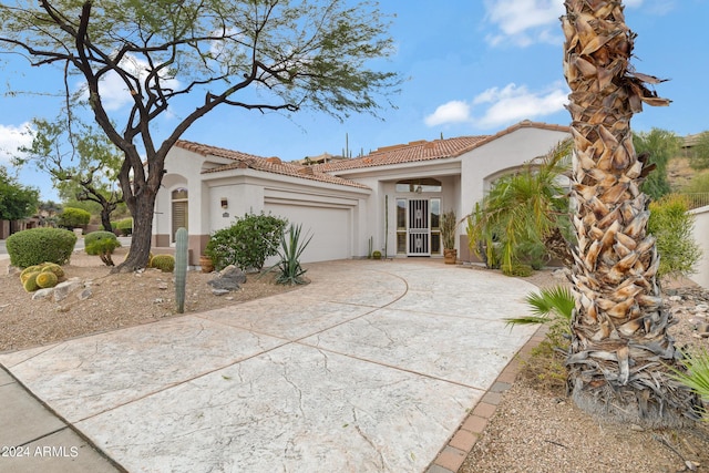 mediterranean / spanish house with a garage