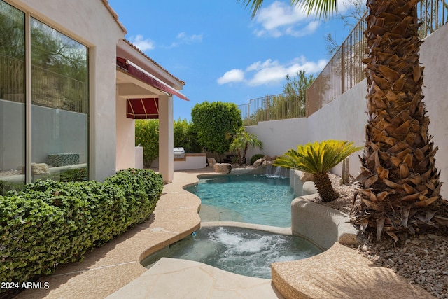 view of swimming pool featuring an outdoor kitchen