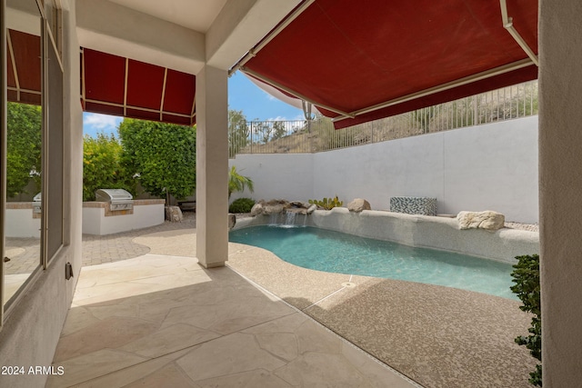 view of pool featuring pool water feature, area for grilling, grilling area, and a patio area