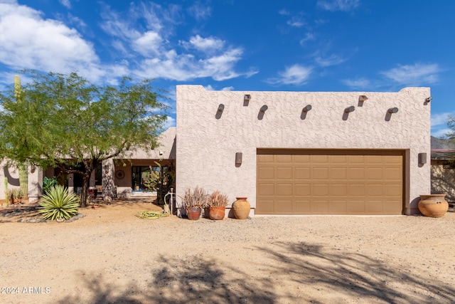 southwest-style home featuring a garage