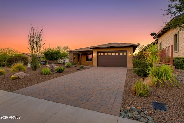 3285 Big Sky Dr, Wickenburg, AZ 85390 - view of front facade featuring decorative driveway, an attached garage, and stucco siding
