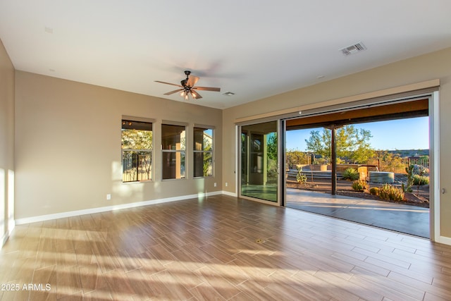 3285 Big Sky Dr, Wickenburg, AZ 85390 - spare room with a ceiling fan, plenty of natural light, baseboards, and wood finished floors