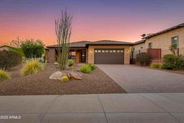 3285 Big Sky Dr, Wickenburg, AZ 85390 - view of front of house featuring an attached garage, driveway, and stucco siding