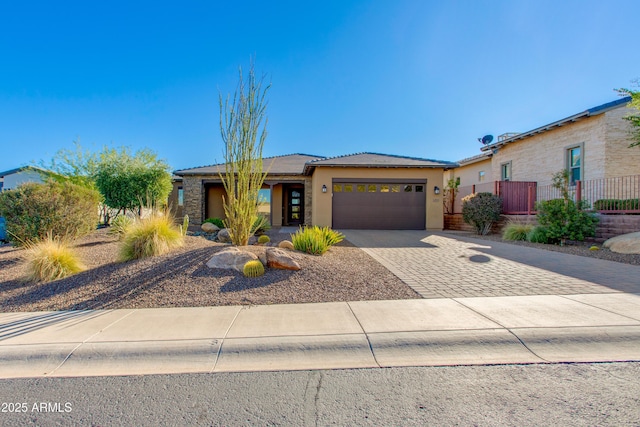 3285 Big Sky Dr, Wickenburg, AZ 85390 - view of front of home with an attached garage, decorative driveway, stucco siding, and a tiled roof