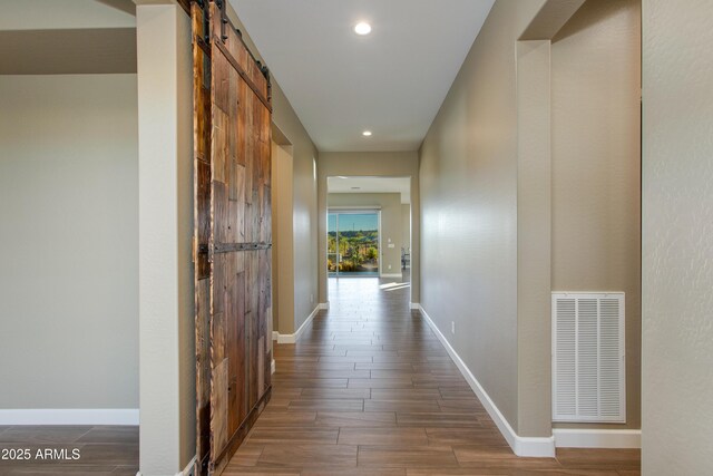 3285 Big Sky Dr, Wickenburg, AZ 85390 - corridor with a barn door, wood finished floors, baseboards, and recessed lighting