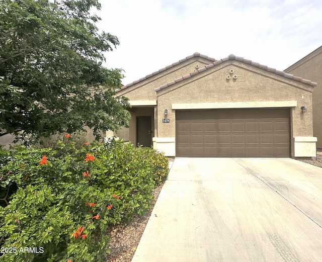 view of front of house featuring stucco siding, an attached garage, and concrete driveway