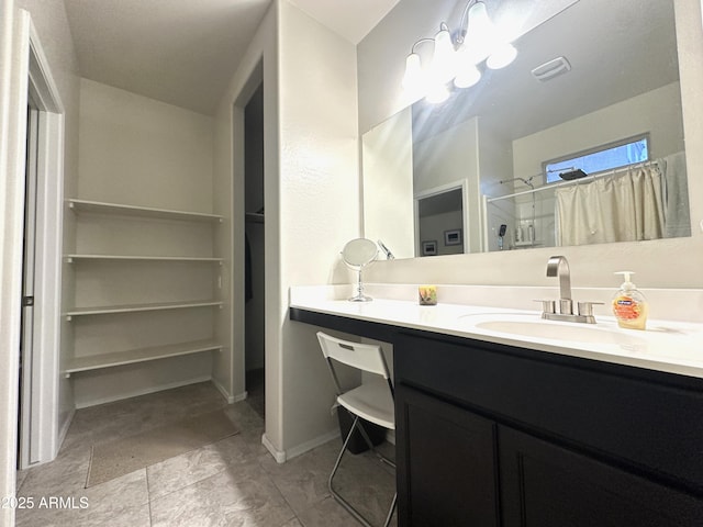 bathroom with vanity, baseboards, and curtained shower