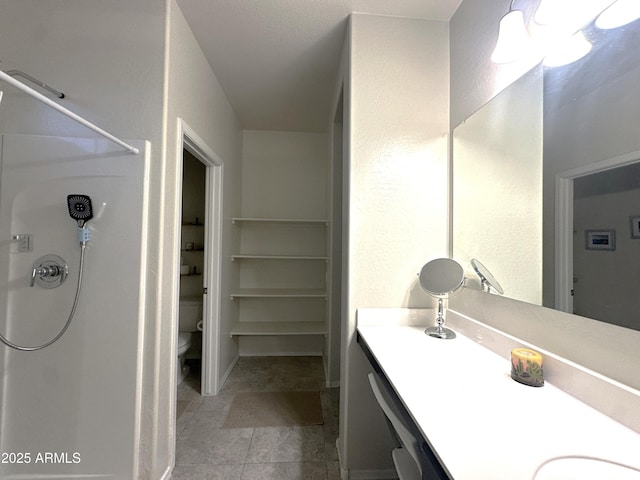 full bathroom with a shower, toilet, vanity, and tile patterned flooring