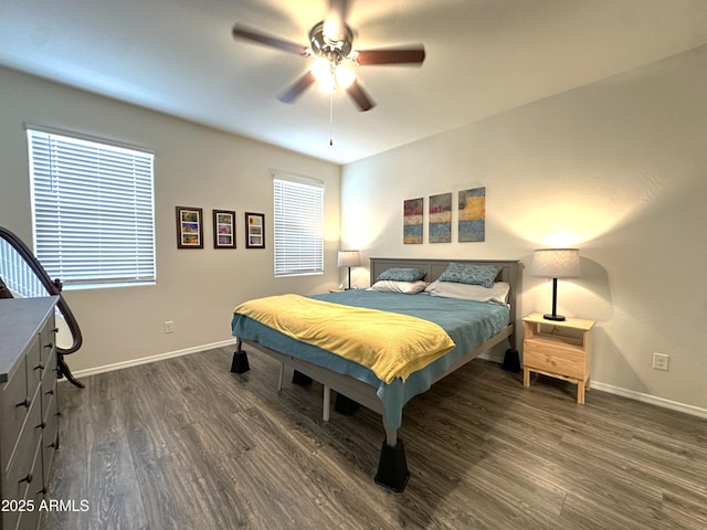 bedroom featuring baseboards, ceiling fan, and dark wood-style flooring