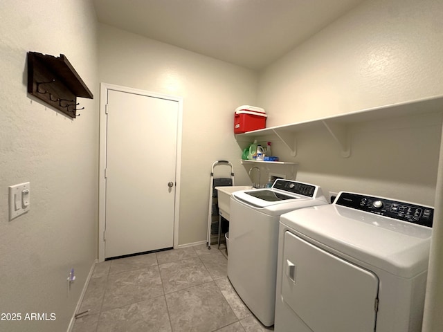 laundry room featuring a sink, laundry area, light tile patterned floors, baseboards, and washer and dryer