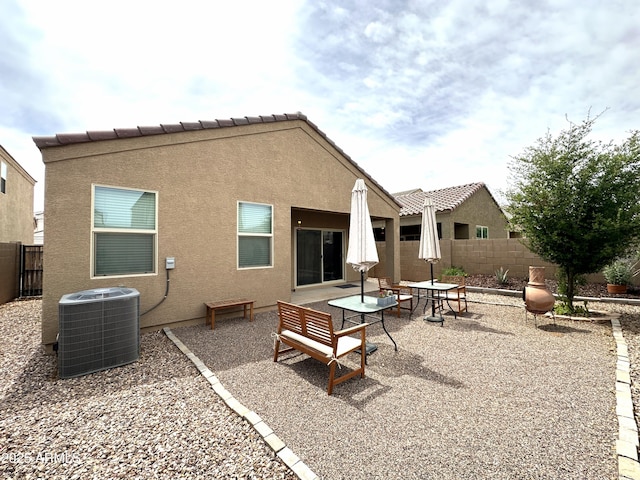back of house featuring a tile roof, a patio area, central air condition unit, stucco siding, and fence