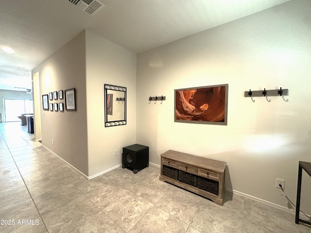 corridor featuring baseboards and visible vents