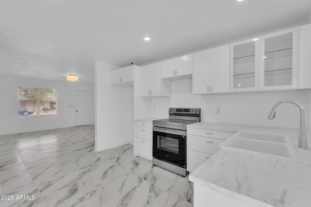 kitchen with a sink, white cabinetry, marble finish floor, stainless steel electric stove, and glass insert cabinets