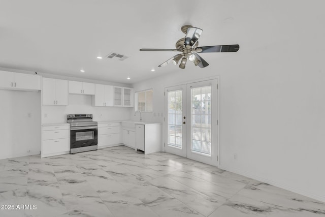 kitchen featuring recessed lighting, a sink, visible vents, white cabinetry, and stainless steel range with electric stovetop