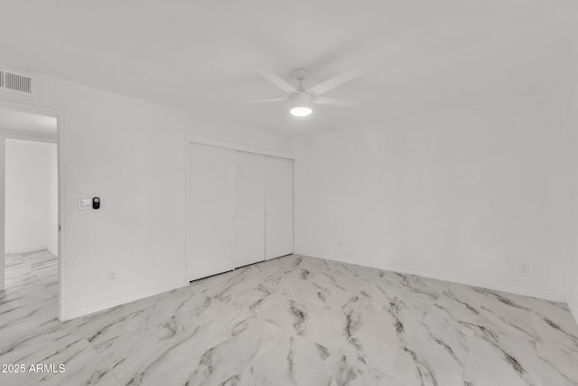 unfurnished room featuring marble finish floor, visible vents, ceiling fan, and baseboards