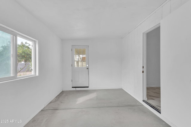 interior space featuring plenty of natural light and concrete flooring