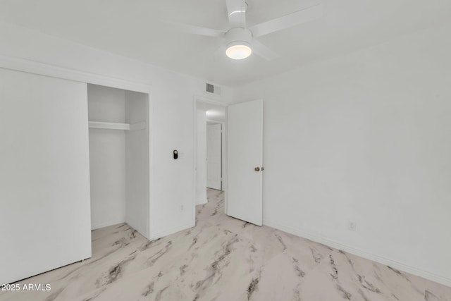 unfurnished bedroom featuring visible vents, baseboards, ceiling fan, marble finish floor, and a closet