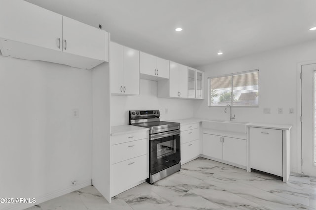 kitchen with electric range, dishwasher, white cabinetry, a sink, and recessed lighting