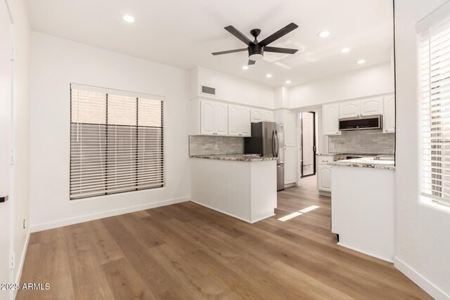 8725 E Via Del Arbor, Scottsdale, AZ 85258 - kitchen featuring stainless steel appliances, tasteful backsplash, ceiling fan, white cabinetry, and recessed lighting