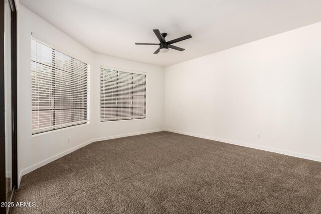 8725 E Via Del Arbor, Scottsdale, AZ 85258 - empty room featuring dark colored carpet and a ceiling fan