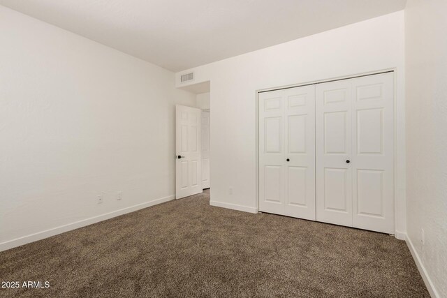 8725 E Via Del Arbor, Scottsdale, AZ 85258 - unfurnished bedroom featuring carpet flooring and a closet