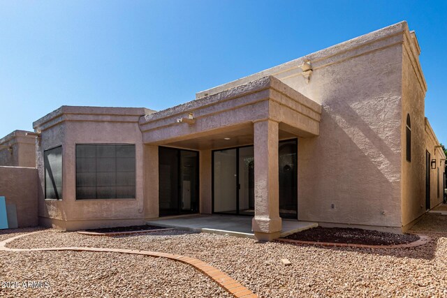 8725 E Via Del Arbor, Scottsdale, AZ 85258 - rear view of house featuring a patio and stucco siding