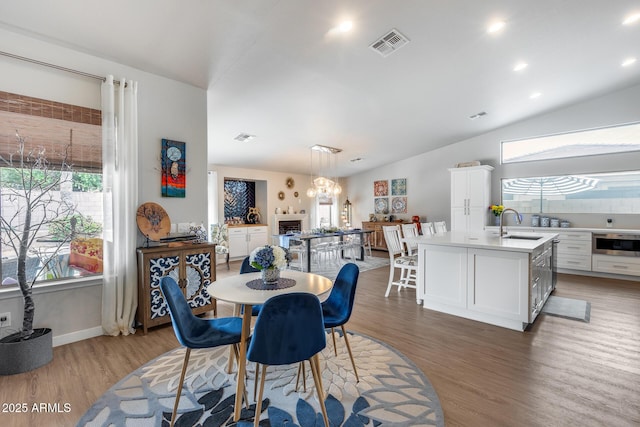 8738 W Runion Dr, Peoria, AZ 85382 - dining space with light wood-style flooring, lofted ceiling, and baseboards