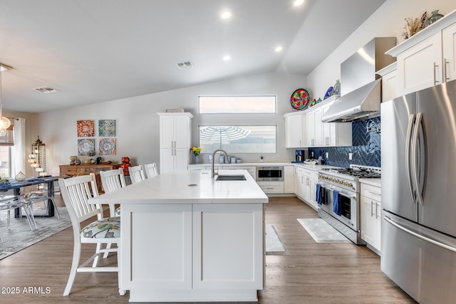 8738 W Runion Dr, Peoria, AZ 85382 - kitchen with appliances with stainless steel finishes, a sink, a kitchen breakfast bar, tasteful backsplash, and white cabinetry